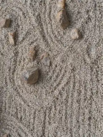 Irregular stones and patterned pale gravel in a Zen garden outside Tokyo, Japan